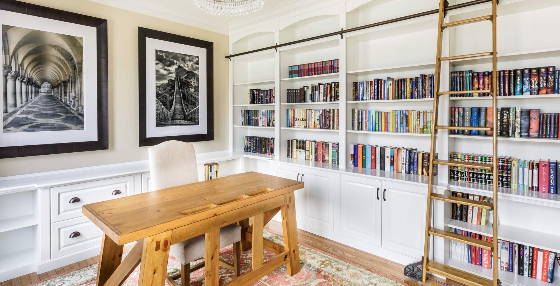 home office with custom bookshelves and a rolling ladder