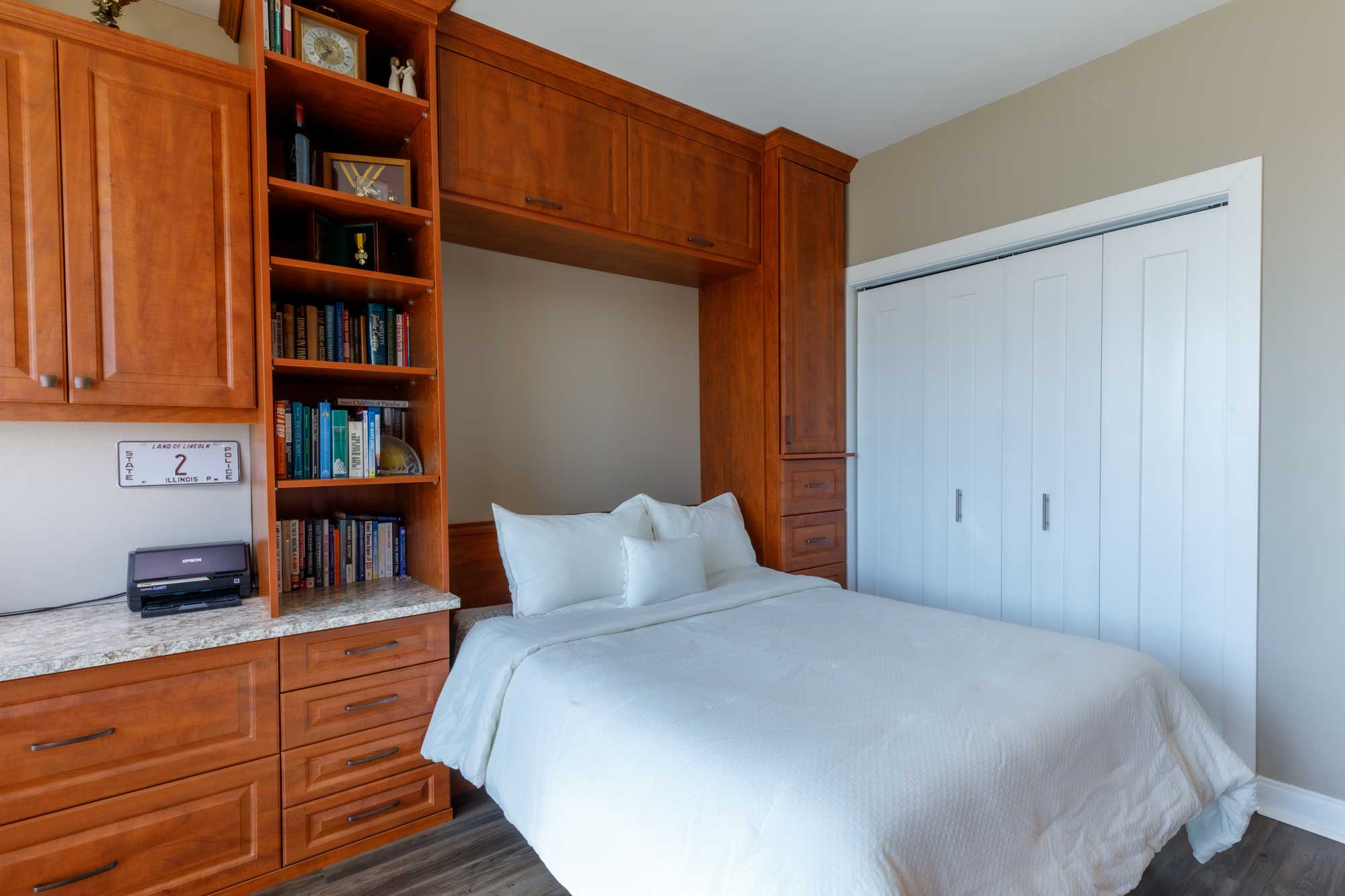 Folded out wall bed with brown custom cabinetry