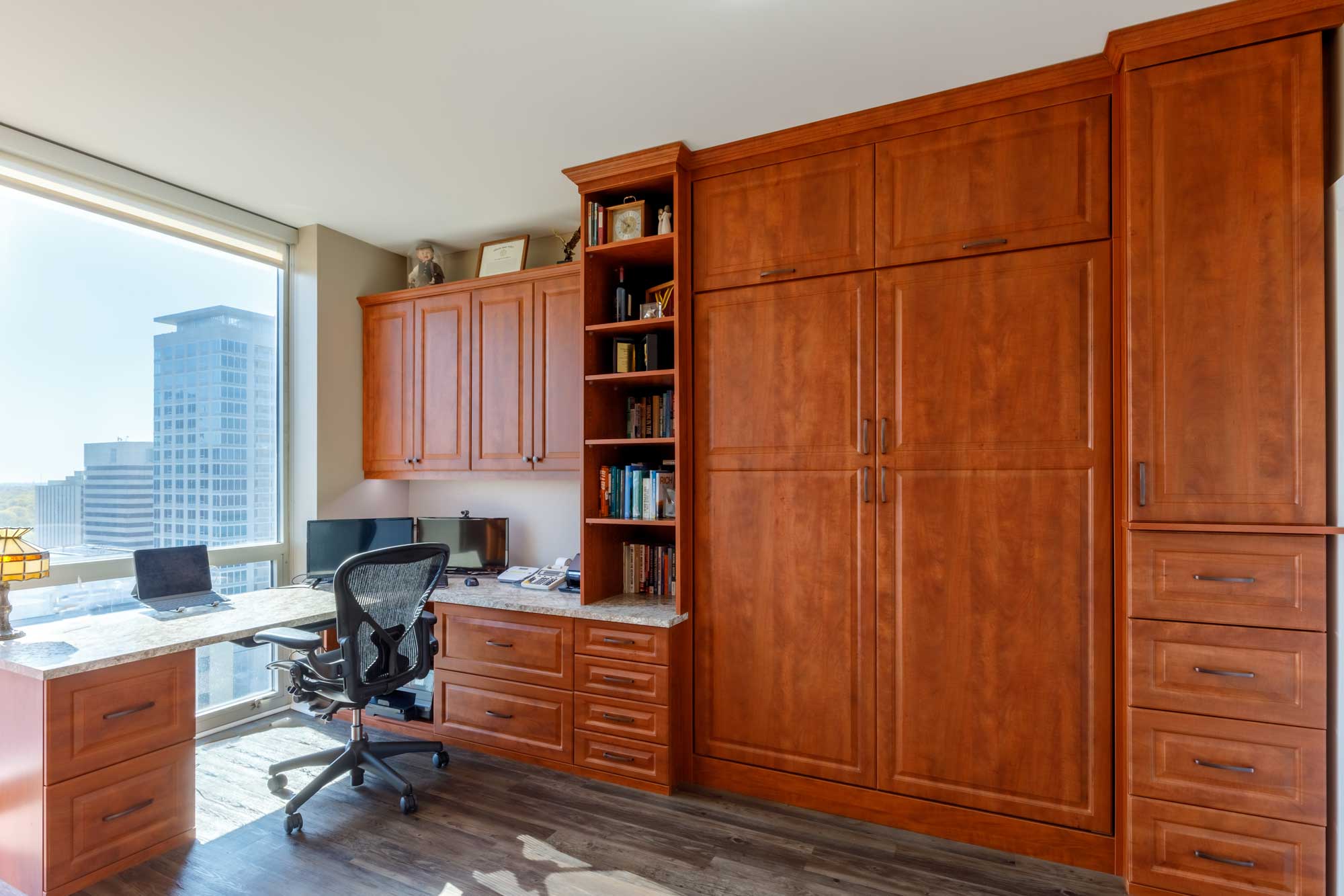 Wall bed with brown custom cabinetry