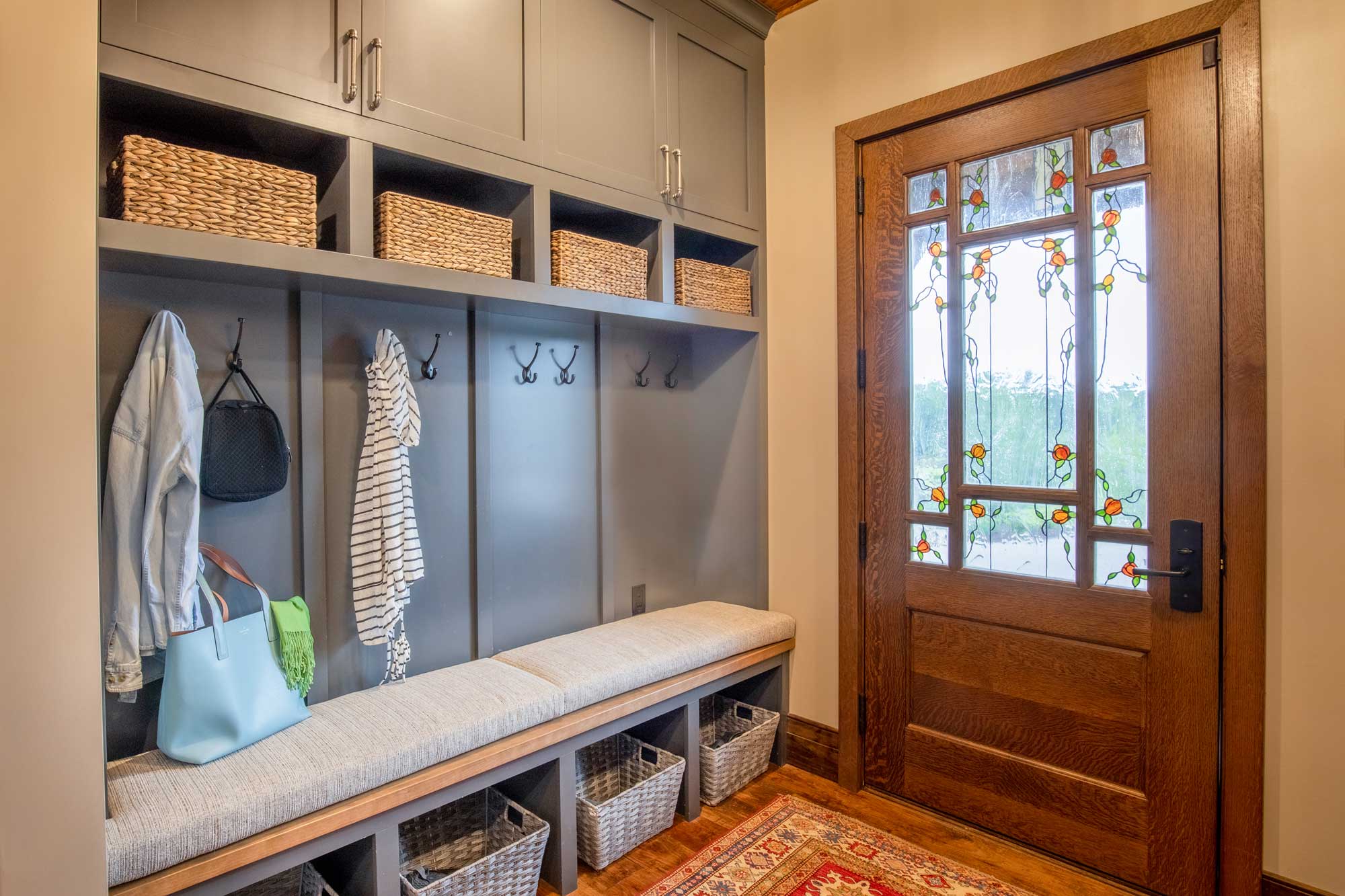 Mudroom storage with coat rack, bench, cabinets
