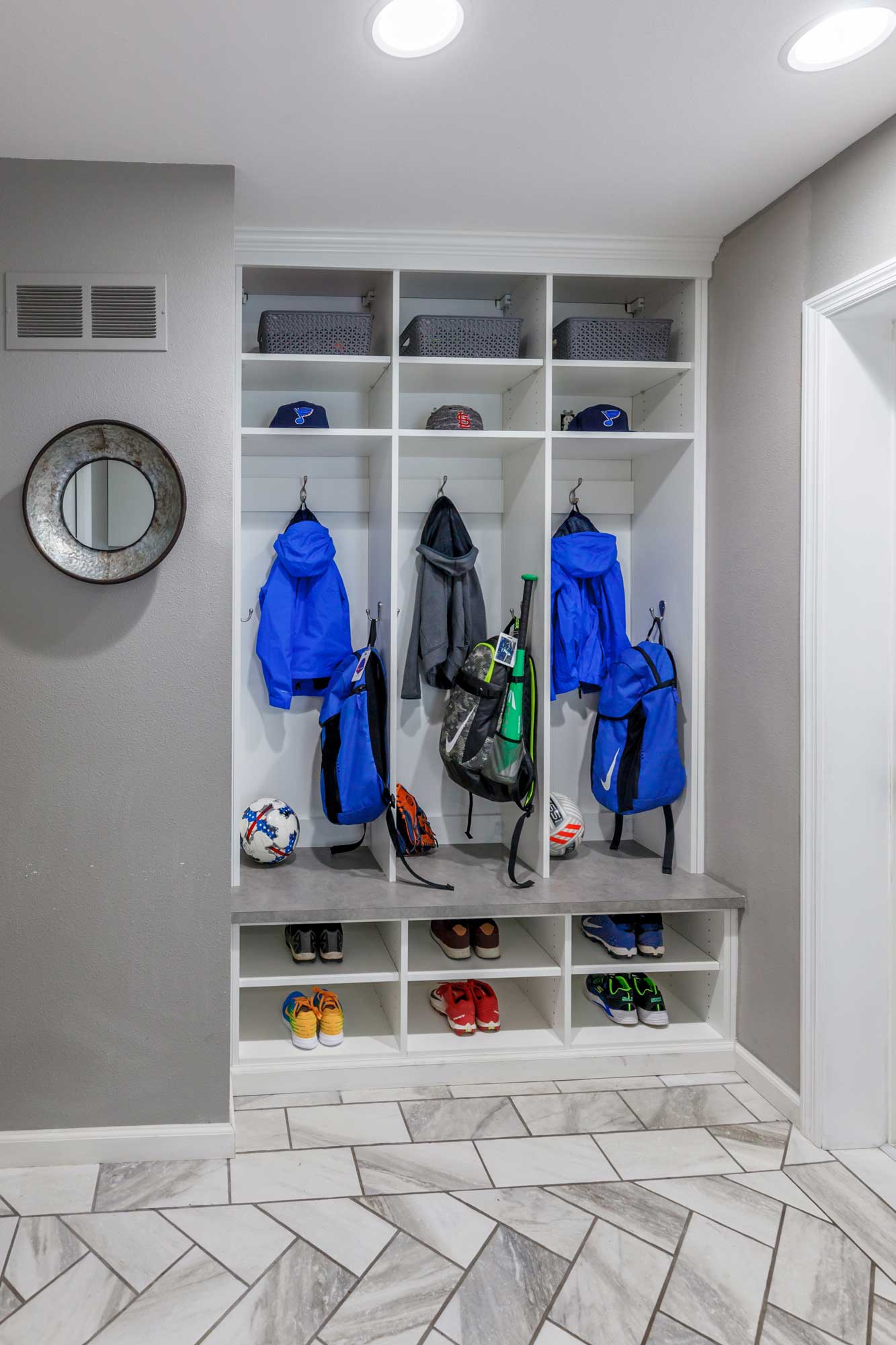 Mudroom storage with coat rack, bench, cabinets